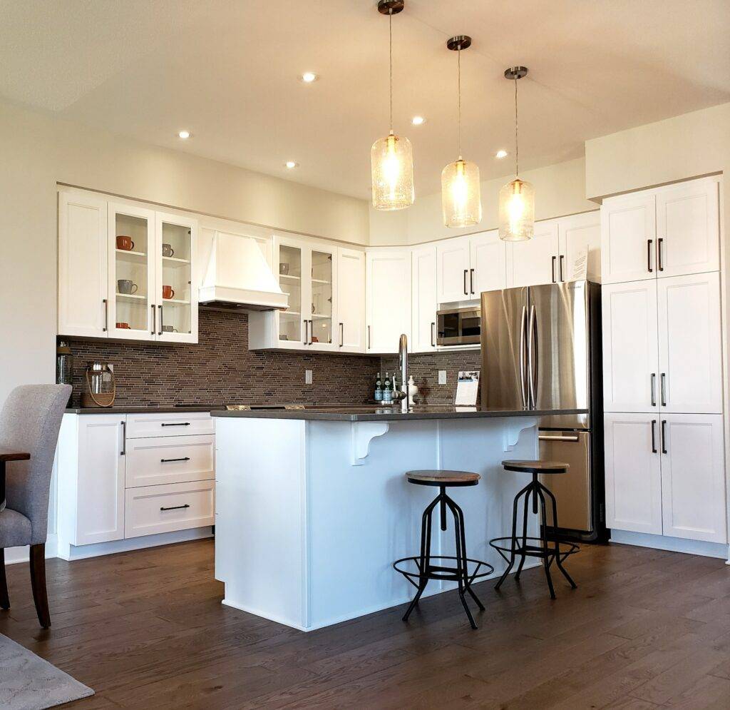 full-view-of-a-renovated-kitchen-plan-with-new-cupboards-and-mosaic-tiled-backsplash-hardwood-floor-1024x995